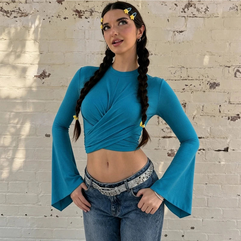 Model wearing a blue twist front flare sleeve crop top