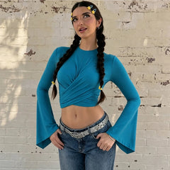 Model wearing a blue twist front flare sleeve crop top