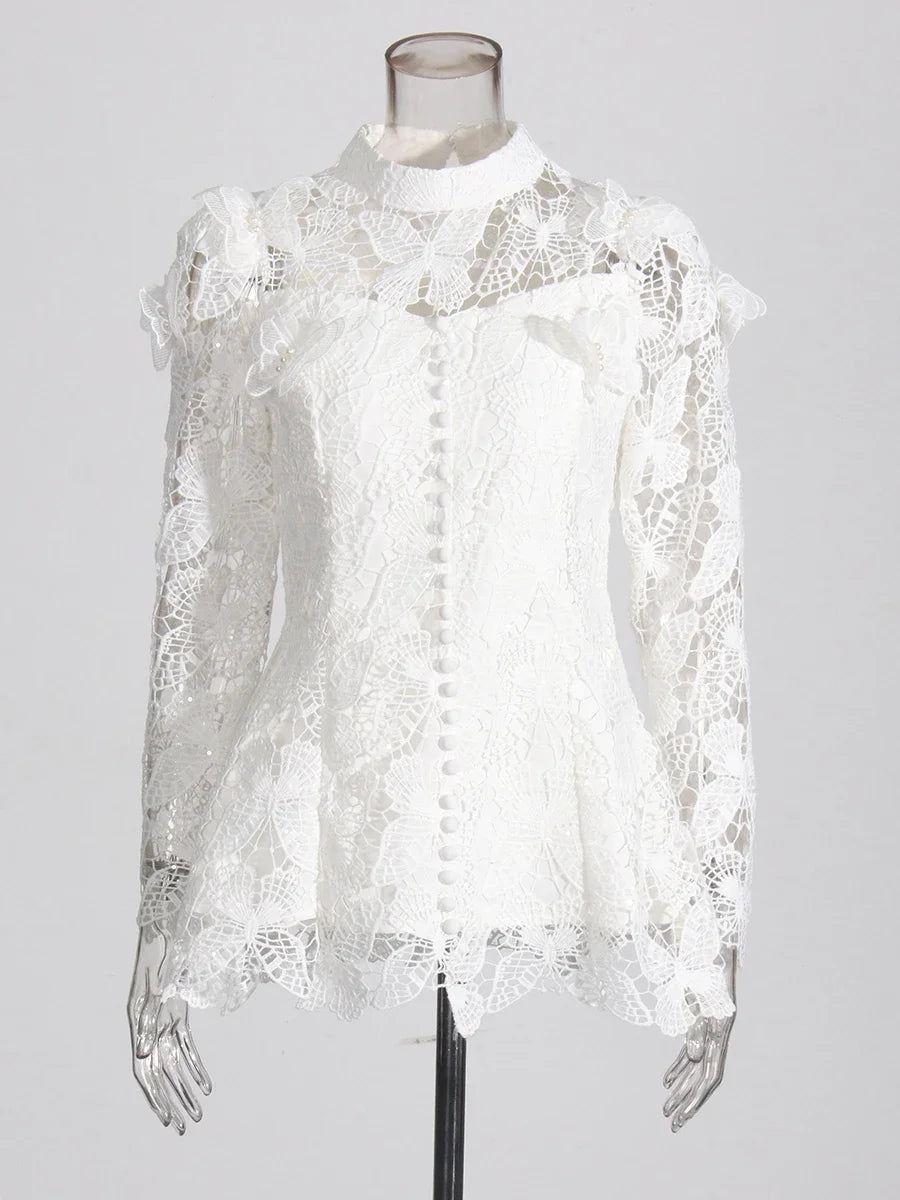White lace blouse on a mannequin against a gray background