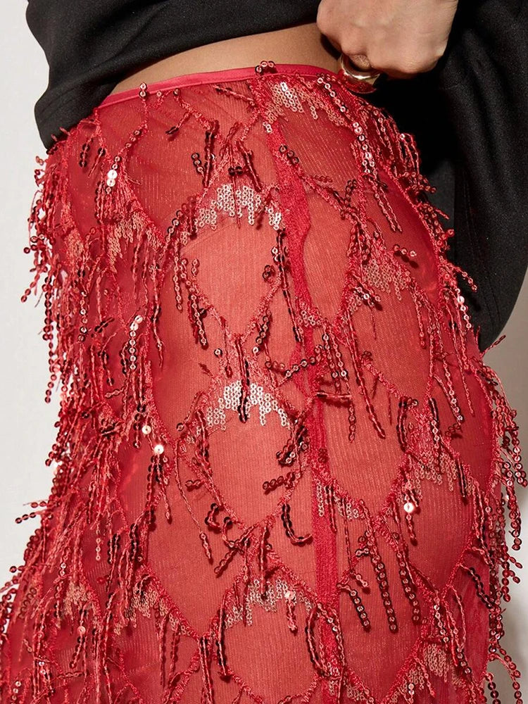 Red beaded skirt with intricate patterns on a plain background