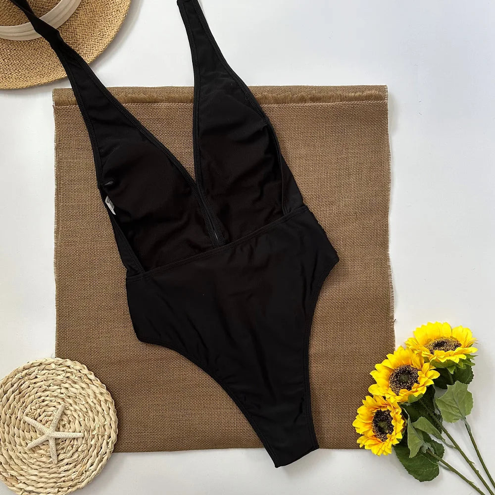 Back view of a black one-piece swimsuit with zipper closure
