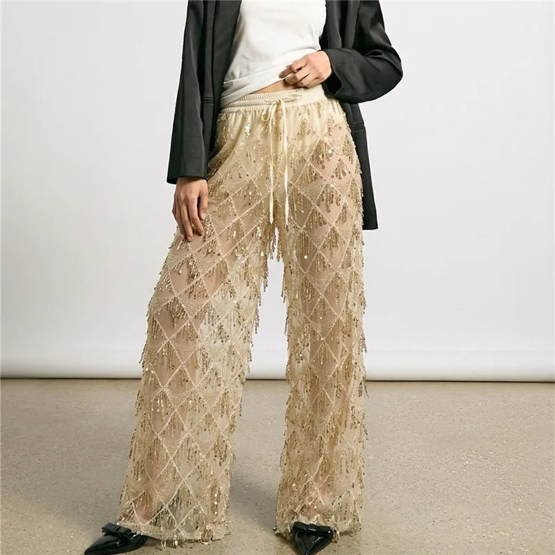 Gold sequin wide leg mesh pants styled with a black blazer