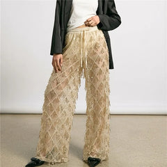 Gold sequin wide leg mesh pants styled with a black blazer