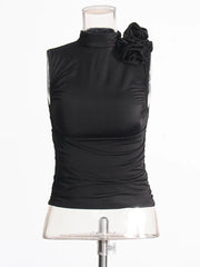 Black sleeveless top with floral details on a mannequin against a white background