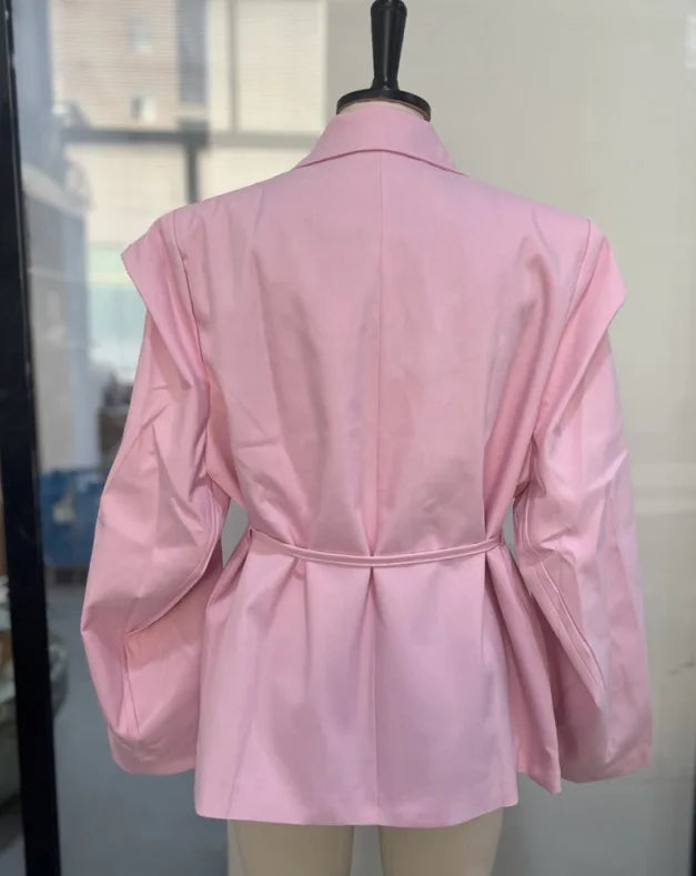 Pink jacket on a mannequin against a neutral background