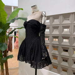 Side view of black lace bow off-shoulder mini dress with long sleeves