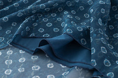 Detail of the chiffon fabric and layered hem on a geometric print mini dress