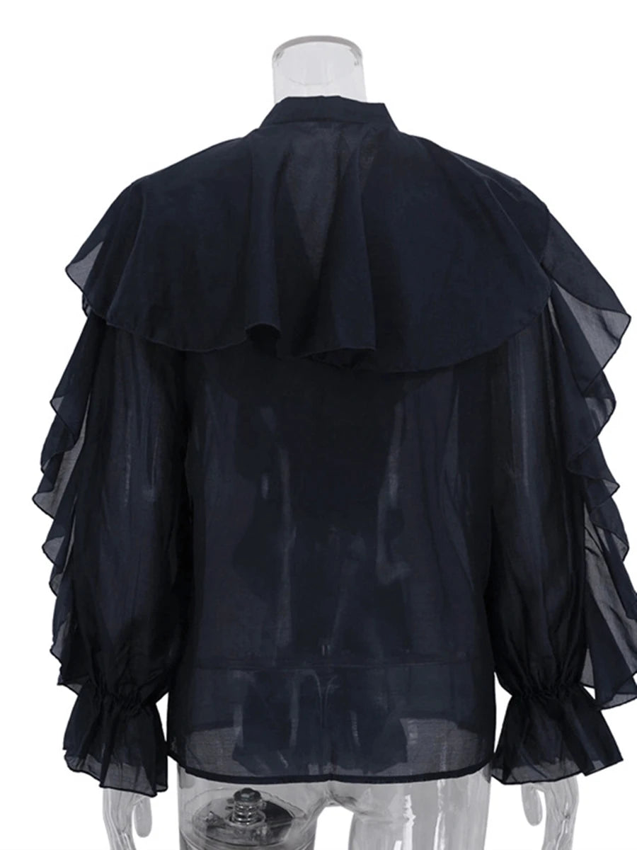 Black sheer blouse on a mannequin with a white background