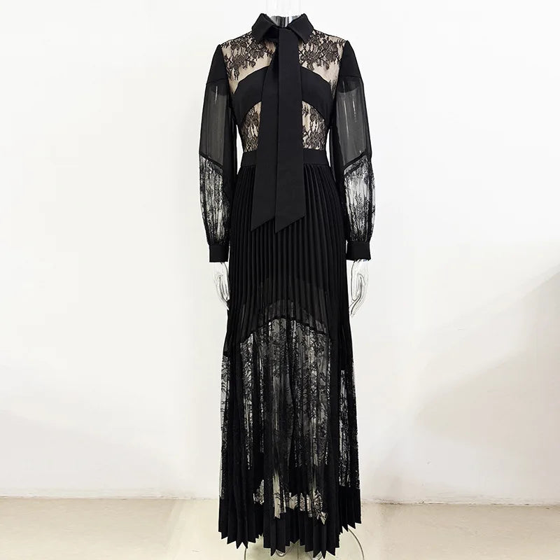 Black lace dress with sheer sleeves on a white background