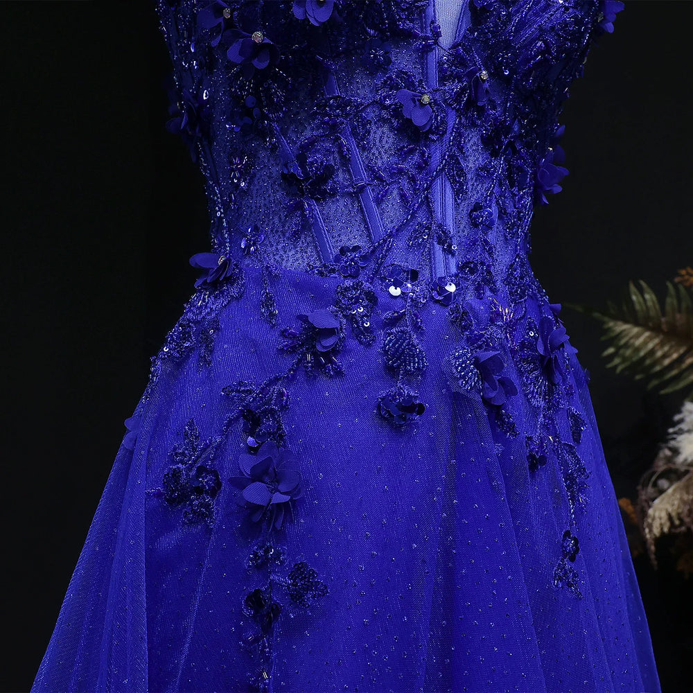 Blue evening gown with floral embellishments on a dark background
