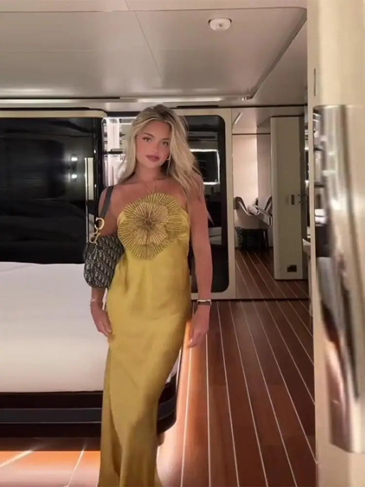 Woman in a yellow dress with a floral top in a modern interior setting