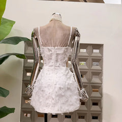 Pearl strap floral mini dress back view beige