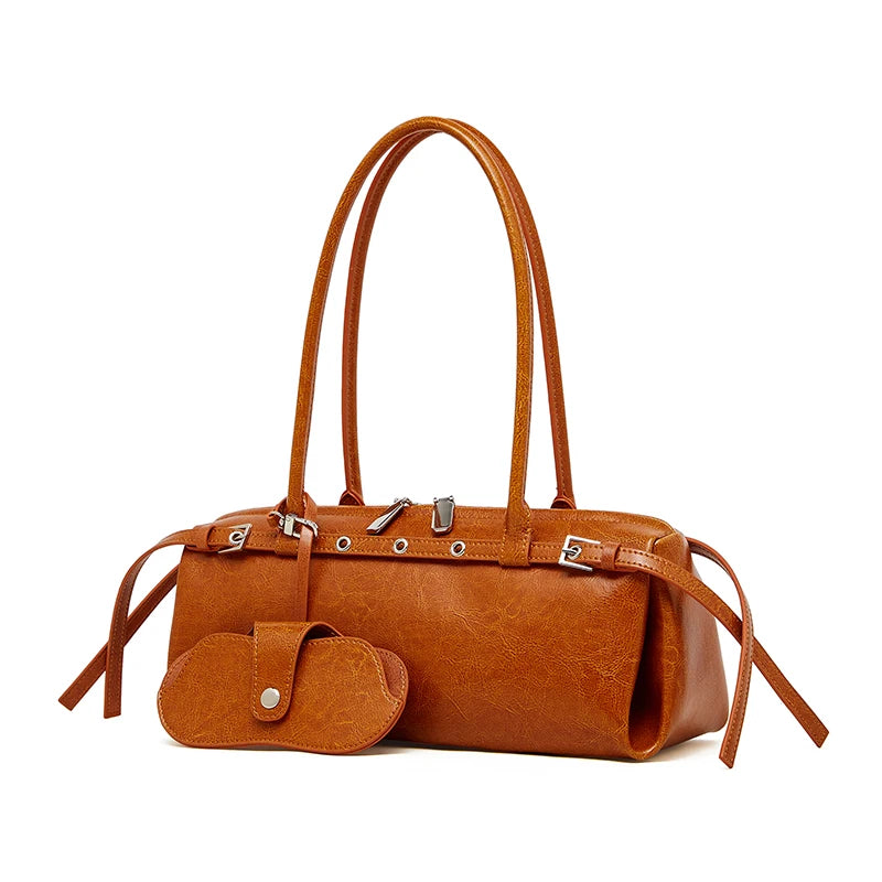 Brown leather handbag with matching pouch on a white background