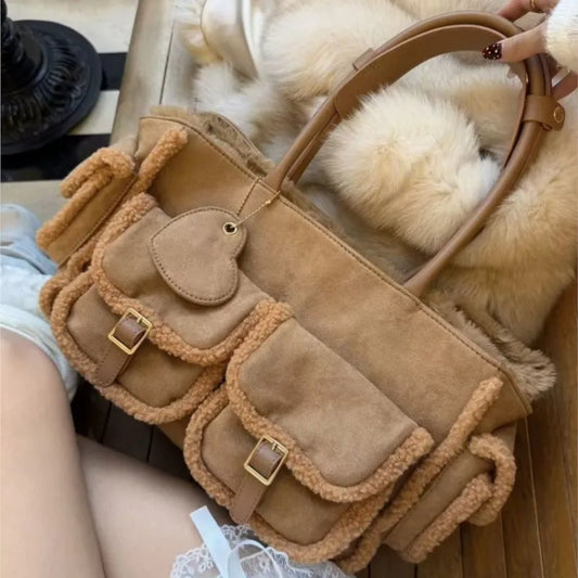 Caramel brown suede tote bag with shearling trim and multiple pockets