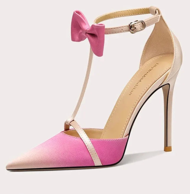 Pink high-heeled shoe with a bow on a white background
