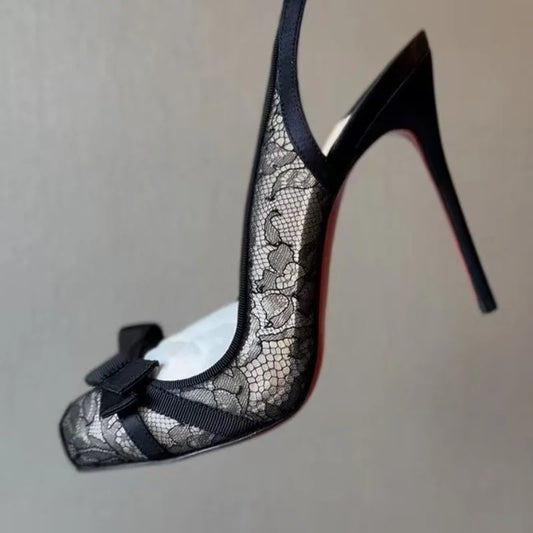 Close-up of black lace slingback heel with bow detail