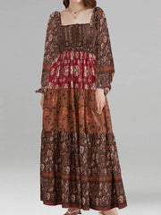 Long, patterned dress with a tiered skirt on a plain background