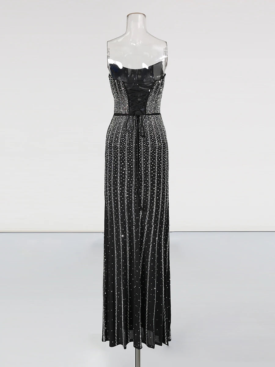 Black sequin evening gown on a mannequin against a white background