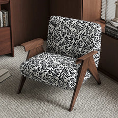 Chair with black leaf pattern on white fabric in a room setting
