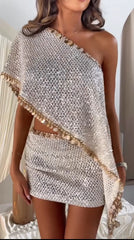 Close-up of sequin detail on one-shoulder cape top and skirt