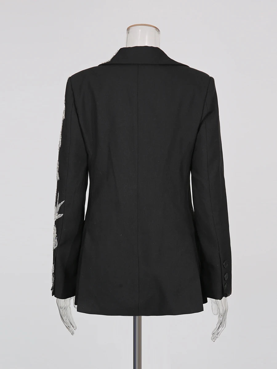 Black blazer on a mannequin against a white background