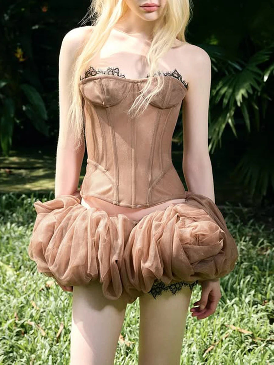 Person wearing a beige corset with a floral skirt outdoors.