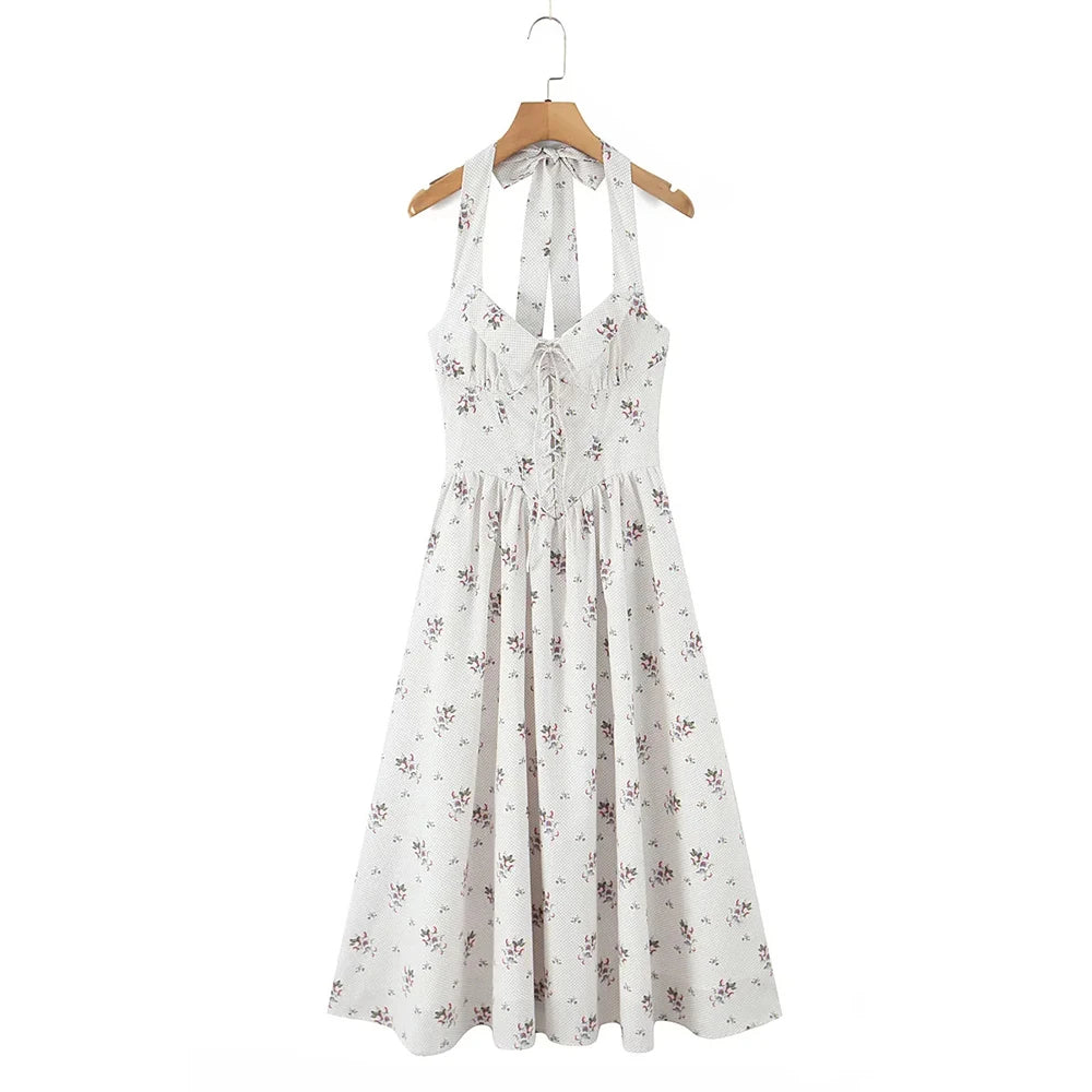 White floral dress on a wooden hanger against a white background
