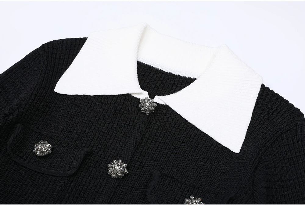 Close-up of black knit cardigan collar and crystal buttons