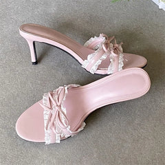 Pink ruffle bow stiletto heel shown from the side.