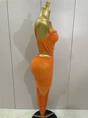 Orange dress on a mannequin against a plain background