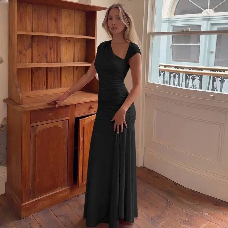 Black asymmetrical neckline maxi dress styled indoors