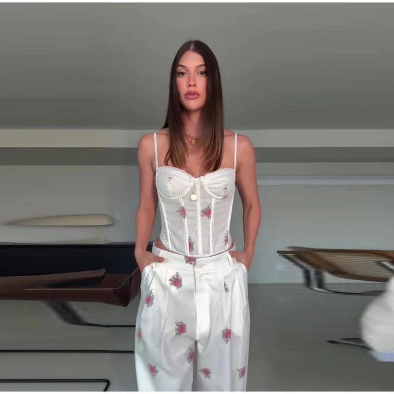 Floral print corset top and wide leg pants set on a model indoors.