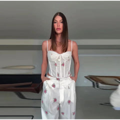 Floral print corset top and wide leg pants set on a model indoors.