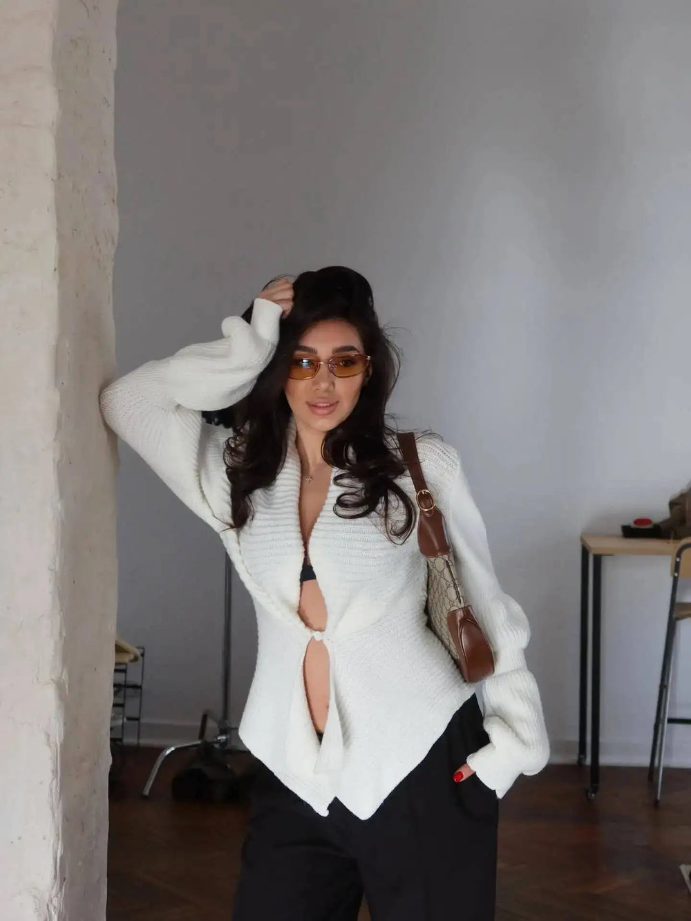 Asymmetrical ribbed knit coat with V-neckline and single button closure.