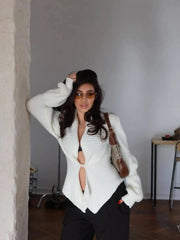 Asymmetrical ribbed knit coat with V-neckline and single button closure.