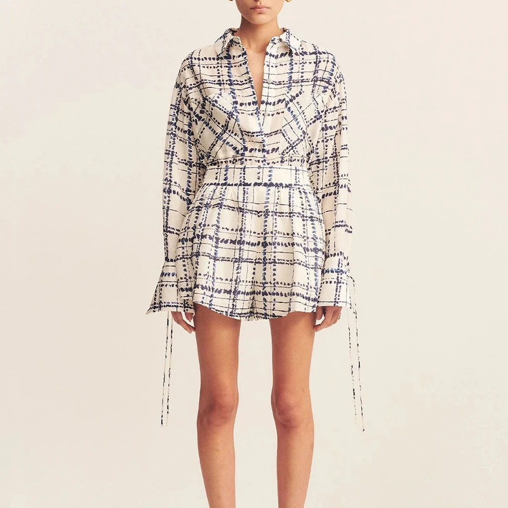 Plaid dress worn by a person on a beige background