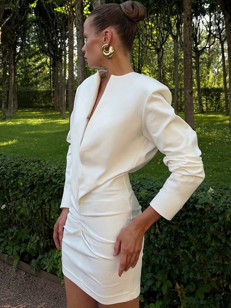 Woman in a white dress standing in a garden