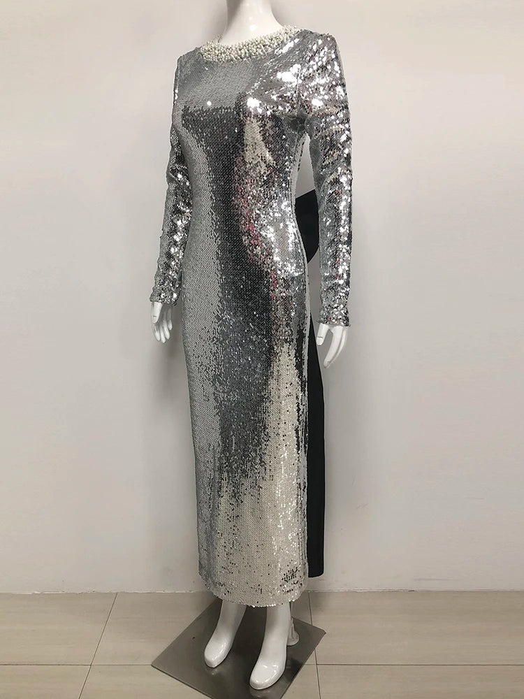 Silver sequin dress on a mannequin against a white background