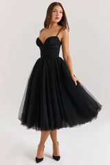 Black tulle dress worn by a model on a white background