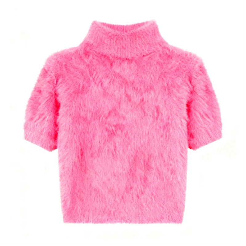 Pink fuzzy sweater on a white background