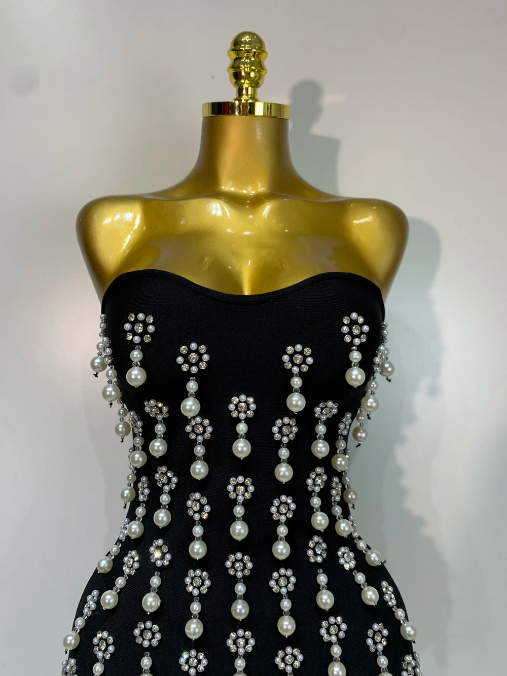 Close-up of embellishments on strapless bodycon mini dress