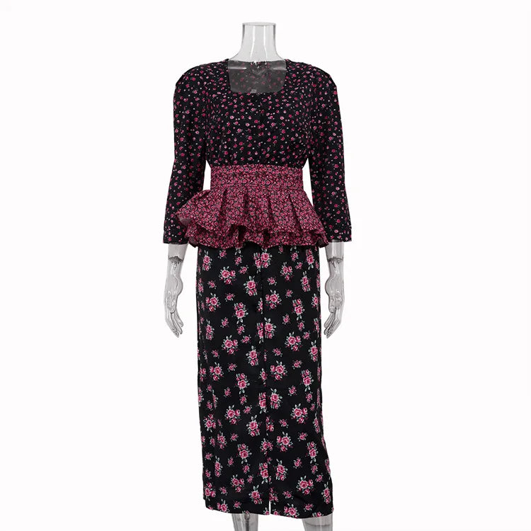 Black floral dress with a peplum top on a mannequin against a white background