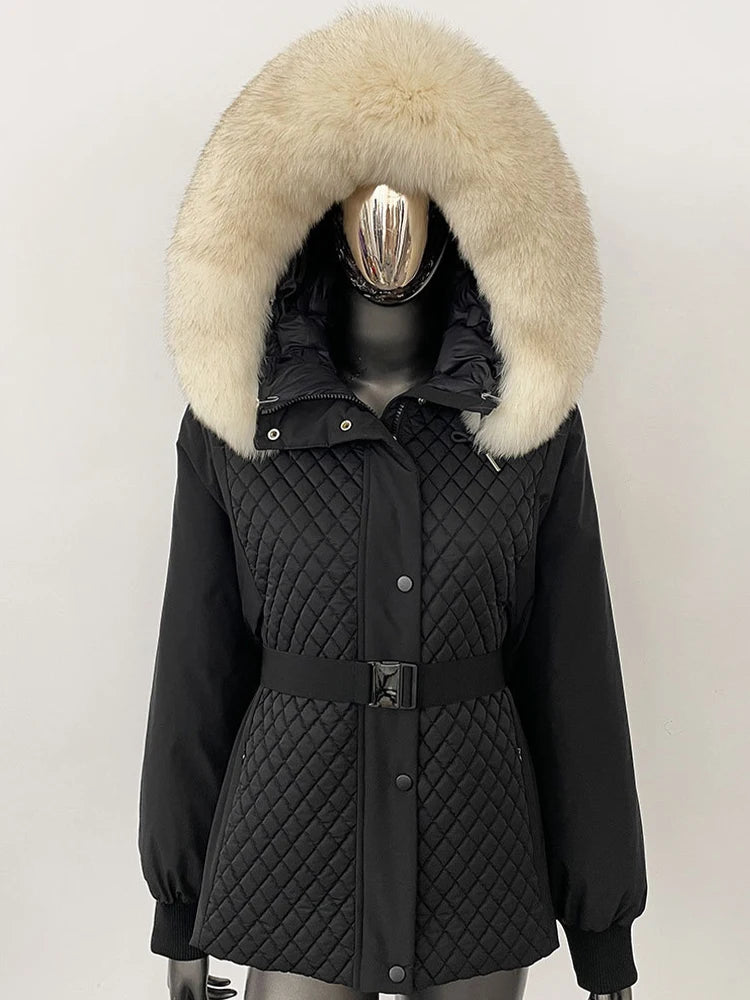 Black quilted jacket with a large fur hood on a mannequin against a white background