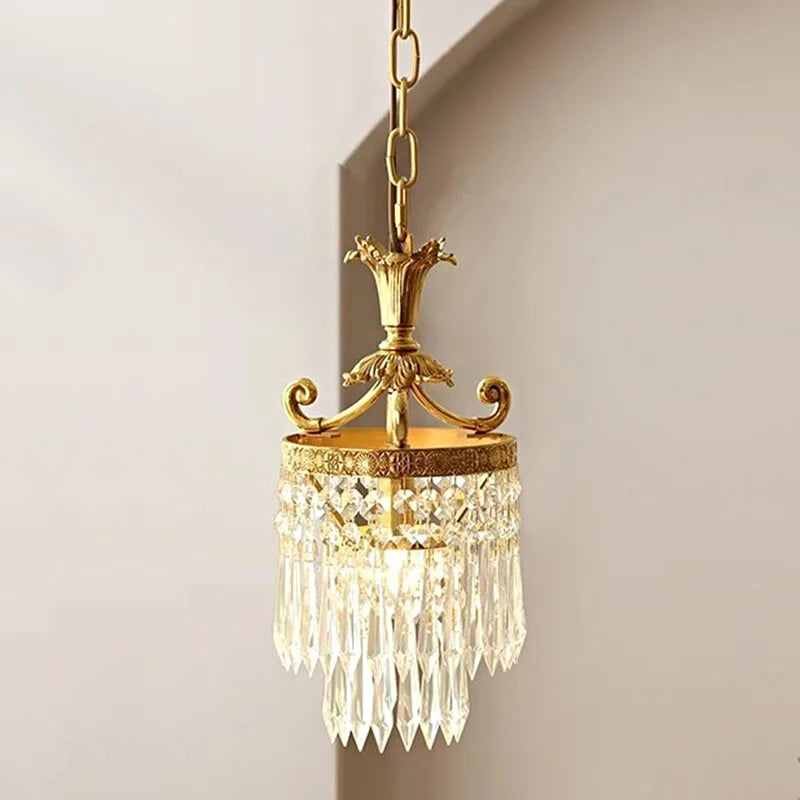 A charming French-style chandelier with a retro copper finish and crystal accents, hanging in a cozy bedroom.