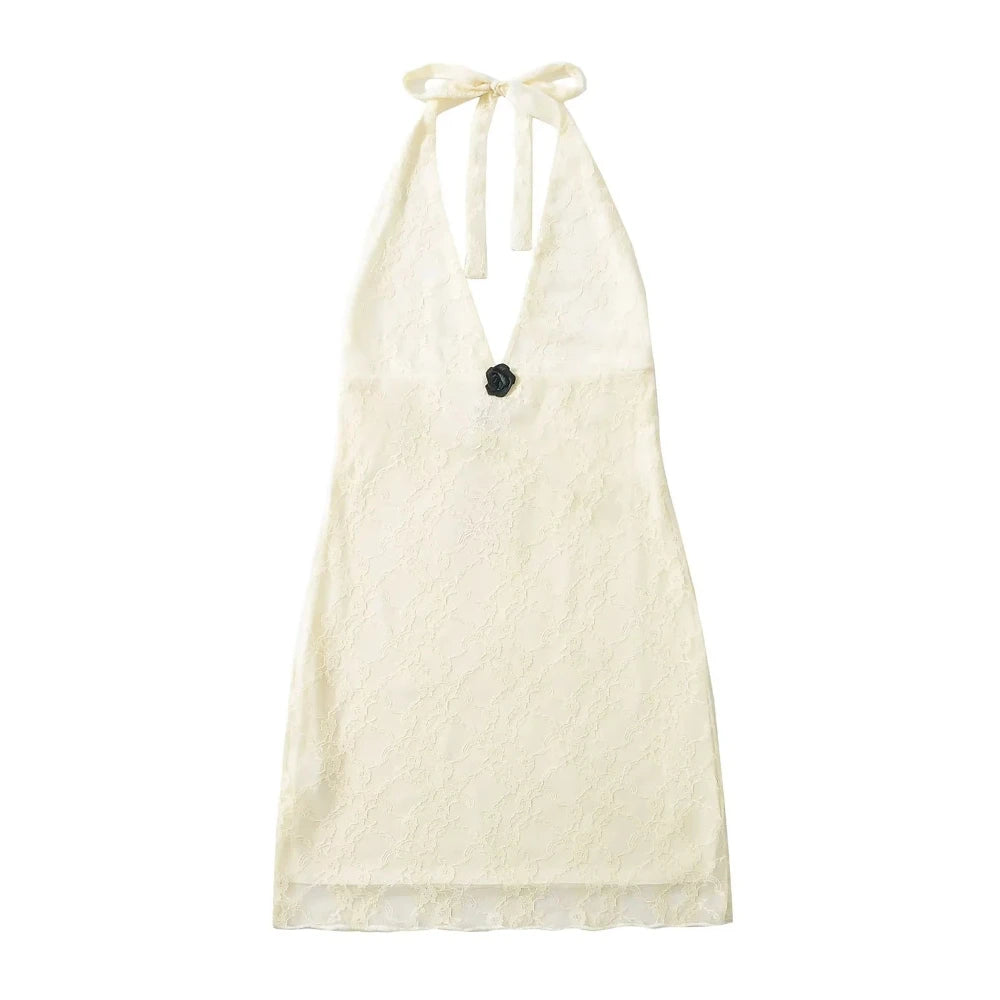 White halter top with black flower detail on a white background