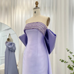 Mannequin displaying the light blue evening dress with beaded cape, showcasing its flattering silhouette and flowing train. Golden Atelier 4