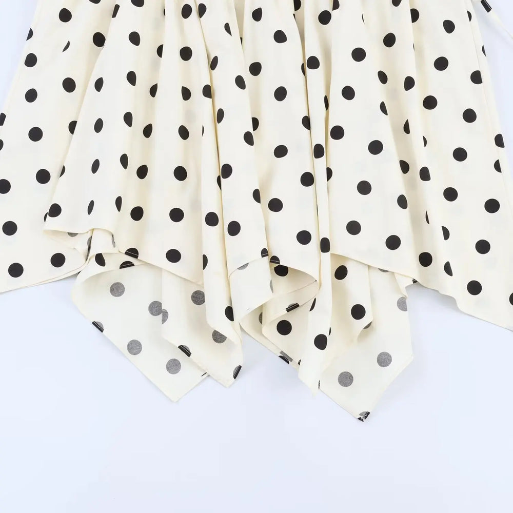 White fabric with black polka dots on a white background