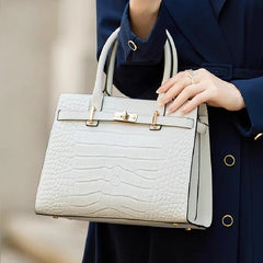 A woman carrying a stylish White leather tote bag, showcasing its versatility and everyday use.