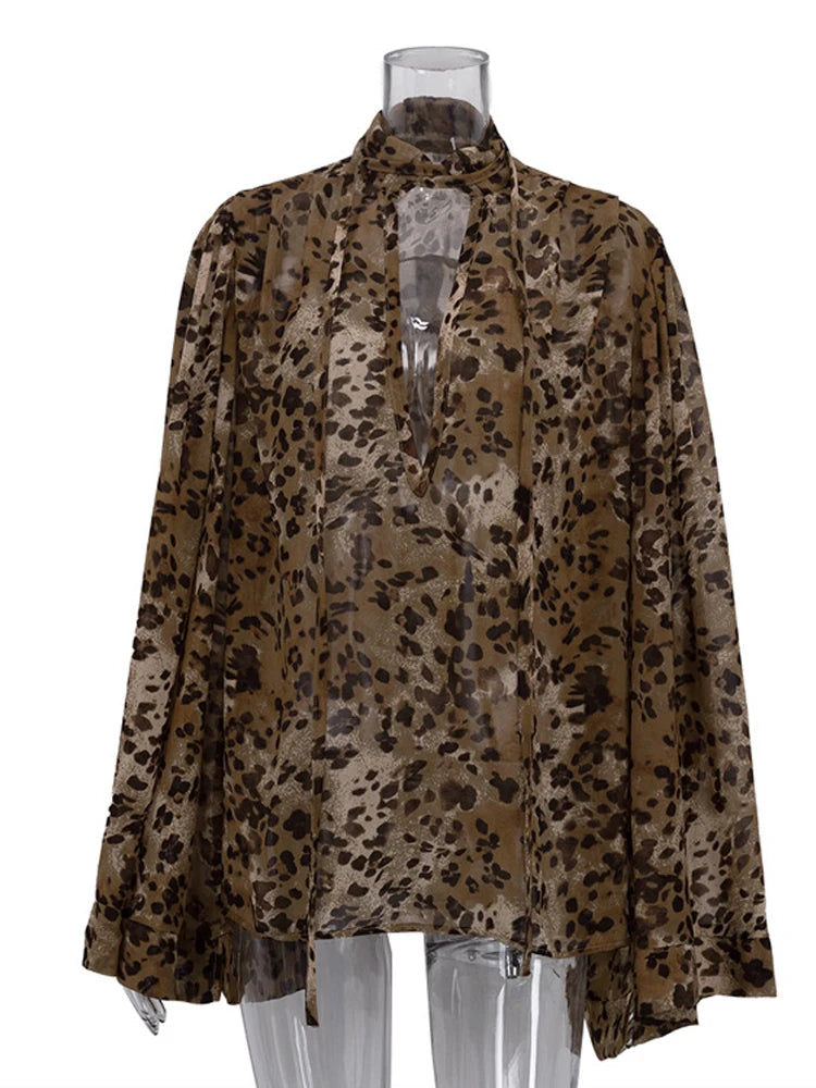 Leopard print blouse on a mannequin against a white background
