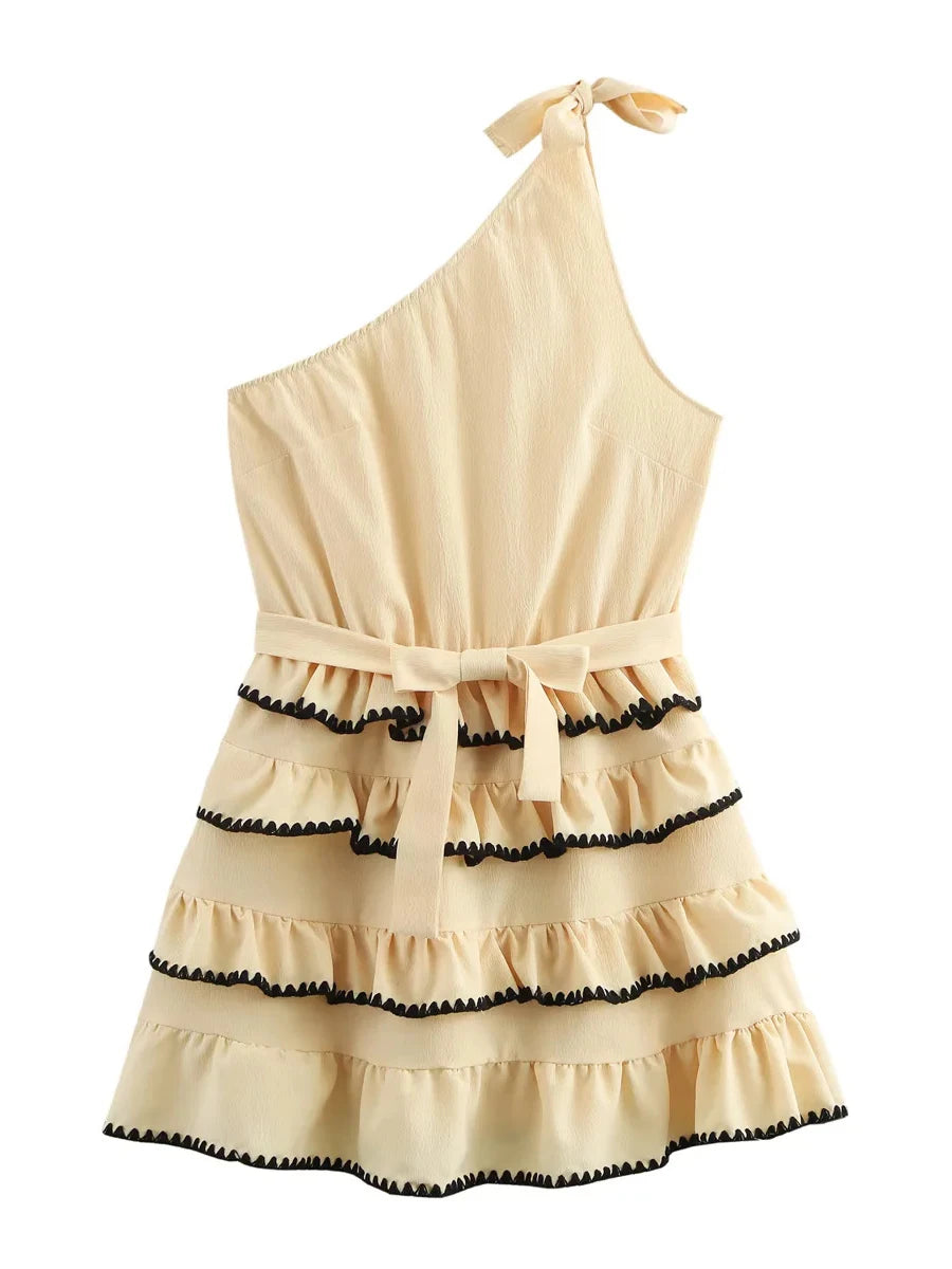 Beige one-shoulder dress with black trim on a white background